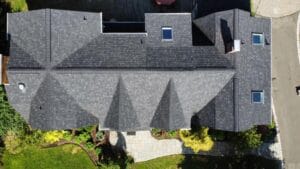 Image of a freshly installed roof, showcasing a clean and well-executed roofing job with visible flashing details and a tidy worksite, emphasizing the careful cleanup process following the renovation